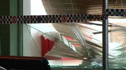 Men seriously injured after falling through Sydney shop window during fight