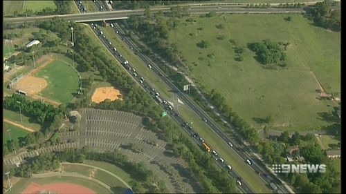 Police are hunting a runaway driver who stabbed another man in the stomach during a road rage incident in Sydney's west.