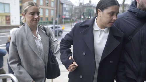 Chelsea and Australia soccer player Sam Kerr, right, arrives with partner Kristie Mewis at Kingston Crown Court, London.