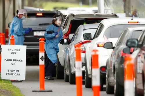 MELBOURNE, AUSTRALIA - JULY 19: Cars are seen lining up at  drive through testing site at Albert Park Lake on July 19, 2021 in Melbourne, Australia. Lockdown restrictions have come into effect across Victoria as health authorities work to contain two COVID-19 outbreaks linked to Sydney's delta strain coronavirus cluster. The snap five-day lockdown, which came into effect at midnight on Thursday, was called after more new COVID-19 cases and exposure sites were confirmed across the state. Under th