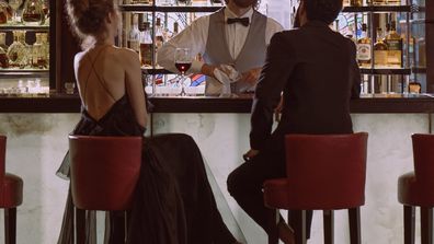 Stock image of a couple sitting at a bar.