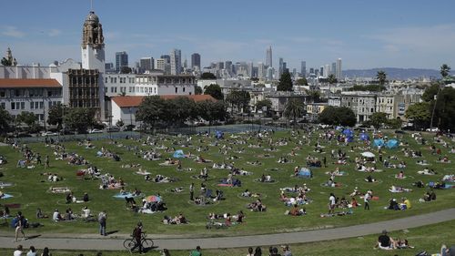 Visitors set up inside circles designed to help prevent the spread of the coronavirus at Dolores Park in San Francisco. 