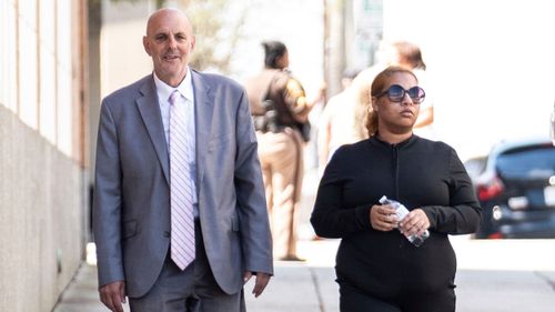 Deja Taylor, right, arrives with attorney James Ellenson, left, at the Newport News Sheriff's Office in Virginia, on April 13.