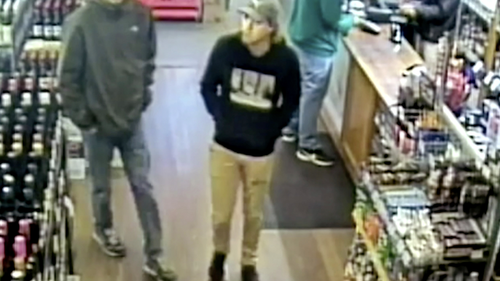 This May 31, 2019, image from CCTV provided Monday, June 17, 2019, by New South Wales Police Force, missing Belgian backpacker Theo Hayez, center, wearing black hooded jumper, inside liquor store in Byron Bay, Australia.