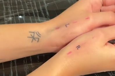 The woman got a dainty "L" and "R" tattooed onto her wrists.