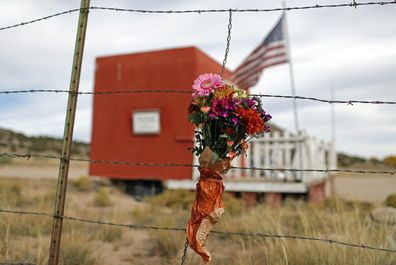 A flower bouquet hangs outside the Bonanza Creek Film Ranch in Santa Fe, N.M., Saturday, Oct. 23, 2021. An assistant director unwittingly handed actor Alec Baldwin a loaded weapon and told him it was safe to use in the moments before the actor fatally shot cinematographer Halyna Hutchins on the set of a Western, court records released Friday show. (AP Photo/Andres Leighton)