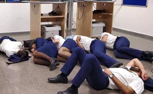 Six Ryanair staff members were sacked over this allegedly staged photograph of them sleeping on an airport floor.