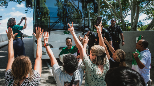Protesters have tried to block a bus taking the Iranian women's football team from their hotel on the Gold Coast to the airport.