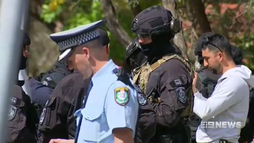 Heavily armed tactical officers swooped on the men in the Audi. (9NEWS)