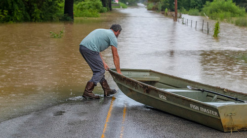 A man prepares to launch a boat near flooded Wolverine Road in Breathitt County, Kentucky, on Thursday, July 28, 2022. 