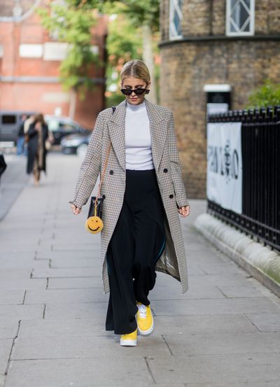 Wide-legged trousers and a pop of bright yellow. That works.