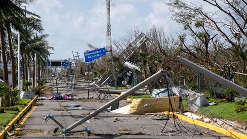 Downed electrical poles and lines blown over by Hurricane Otis