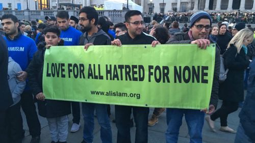 Members of the Ahmadiyya Muslim Community organisation spreading a message of love and acceptance at the vigil. (Henri Paget/9NEWS)