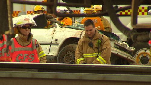 A driver has been cut from the wreckage of his car, after he crashed into a freight train at Two Wells north of Adelaide. (9NEWS)