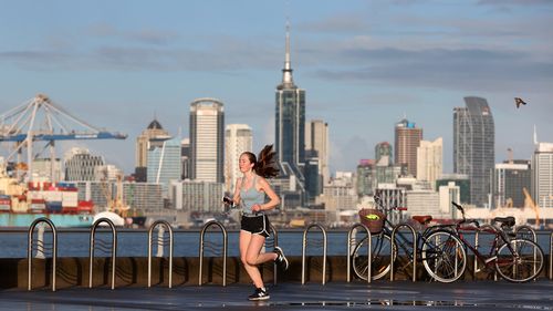 A lone runner along Devonport's waterfront as Auckland wakes to level four lockdown.