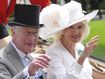 Britain&#x27;s King Charles III and Queen Camilla wave to the crowds as they arrive by carriage in the parade ring on the third day of the Royal Ascot, horse race meeting, traditional known as Ladies Day, at Ascot, England, Thursday, June 20, 2024. (AP Photo/Kin Cheung)