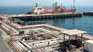 Oil pipelines snake through the port area of the Aramco facility at Ras Tannura, Saudi Arabia