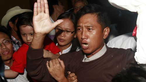 Kyaw Min Yu, a pro-democracy activist talks to journalists as he arrives at Yangon airport welcomed by his wife Nilar Thein, background, also an activist and his daughter after being released from a prison on Jan. 13, 2012, in Yangon. 