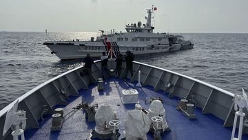 A Chinese coast guard ship blocks a coast guard vessel from the Philippines.