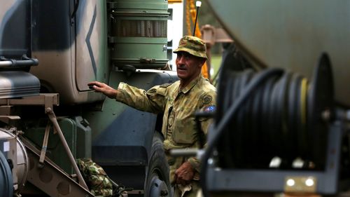 Corporal Justin Perry 4th Squadron 5ER is seen ahead of Australian Army Reserve and Regular personnel departing the Holsworthy Barracks to support bushfire efforts across NSW