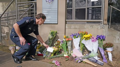 Victoria Police Deputy Commissioner Shane Patton lays a tribute at Boroondara Police near the Chandler Highway in the suburb of Kew in Melbourne, Thursday, April 23, 2020. Four police officers have died in a horror crash involving a truck on Melbourne's Eastern Freeway. (AAP Image/Scott Barbour) NO ARCHIVING