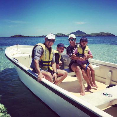 Karyn Sutton with her family in a boat in Fiji