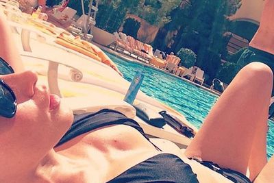 Emily posted a sunbaking selfie at Wynn's Encore Beach Club, as Shane, 44, and his kids swam in the pool below.<br/><br/>"Soaking it up," she captioned the hot bikini Insta-snap. Way to escape that Aussie Winter guys! <br/><br/>Image: @emilyscottofficial/Instagram