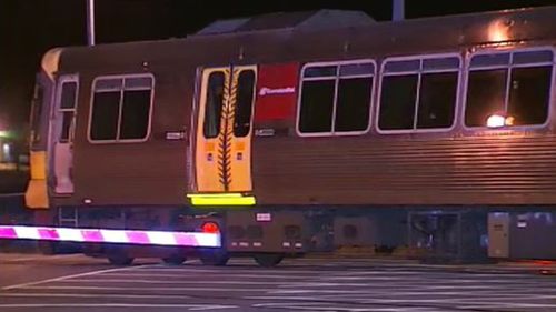 Queensland man hit by train after dodging lowered boom gate while being chased