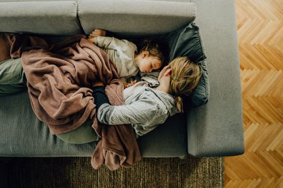 Mum and toddler having a nap on the couch