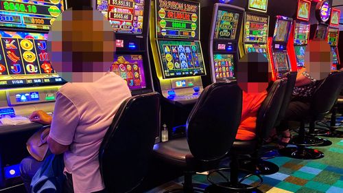 Patrons gamble on the poker machines at a venue in Sydney, NSW.