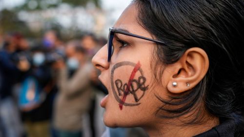A university student shouts slogan during a protest rally against recent gang rape of a girl in New Delhi, in Kolkata, India, Saturday, Jan. 29, 2022. 