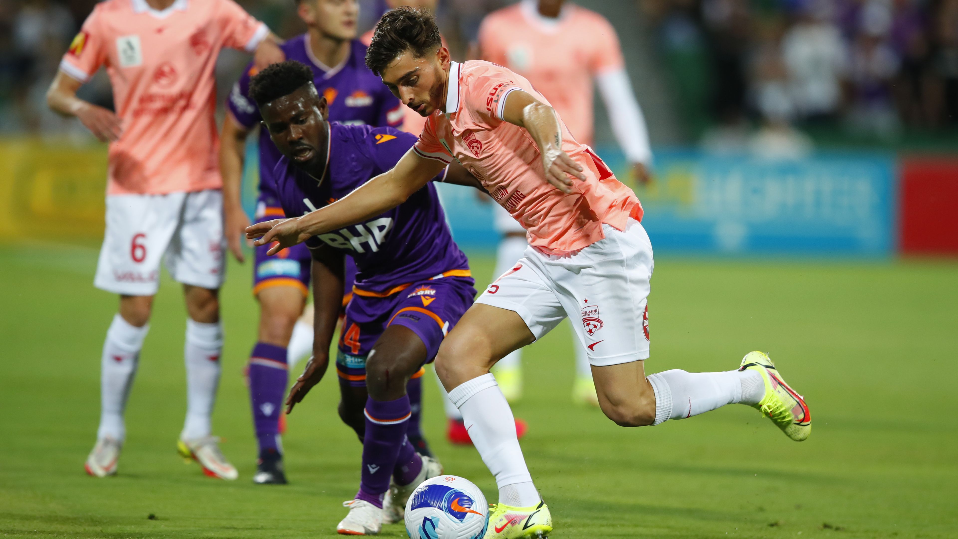 Josh Cavallo of Adelaide United fends off Pacifique Niyongabire of the Perth Glory during an A-League match.