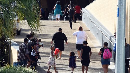 Mourners arrive at the Cairns Convention Centre for the memorial service for eight children. (AAP)