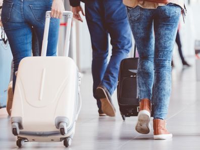 Woman pulling suitcase in an airport