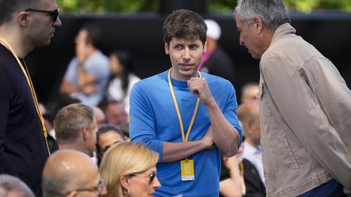 OpenAI CEO Sam Altman, centre, attends the Apple event in Cupertino.