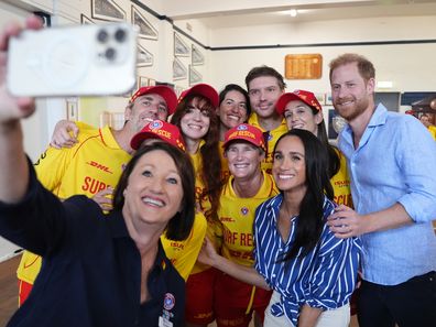 Meghan, Duchess of Sussex and Prince Harry, Duke of Sussex pose for a selfie as they meet volunteer first responders from Bondi Surf Bathers' Life Saving Club, during a visit to Bondi Beach, on day four of the royal trip to Australia on April 17, 2026 in Sydney, Australia. 