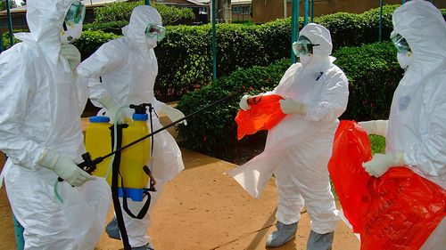 World Health Organisation officials wear protective gear as they prepare to a Uganda hospital where suspected Ebola patients are isolated (Getty)