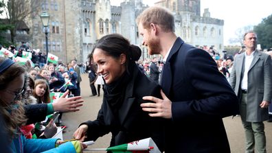Prince Harry and Meghan Markle sign autographs and shake hands with children as they arrive to a walkabout at Cardiff Castle on January 18, 2018 in Cardiff, Wales.  (Photo by Chris Jackson/Chris Jackson/Getty Images)