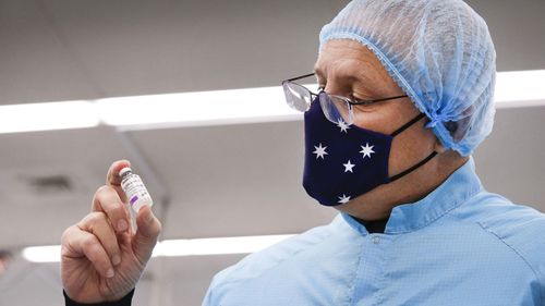 Prime Minister Scott Morrison holding a vial of the AstraZeneca vaccine in Melbourne in February.