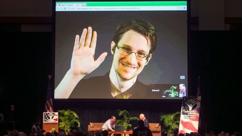 In this Feb. 14, 2015, file photo, Edward Snowden appears on a live video feed broadcast from Moscow at an event sponsored by ACLU Hawaii in Honolulu. 