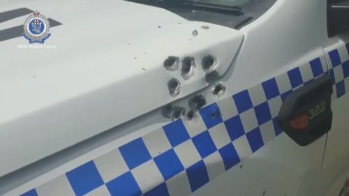 Bullets riddled the NSW Police car during the late night incident.