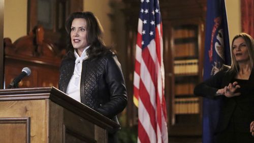 In a photo provided by the Michigan Office of the Governor, Michigan Gov. Gretchen Whitmer addresses the state during a speech in Lansing, Mich., Thursday, Oct. 8, 2020. The governor delivered remarks addressing Michiganders after the Michigan Attorney General, Michigan State Police, U.S. Department of Justice, and FBI announced state and federal charges against 13 members of two militia groups who were preparing to kidnap and possibly kill the governor. (Michigan Office of the Governor via AP)