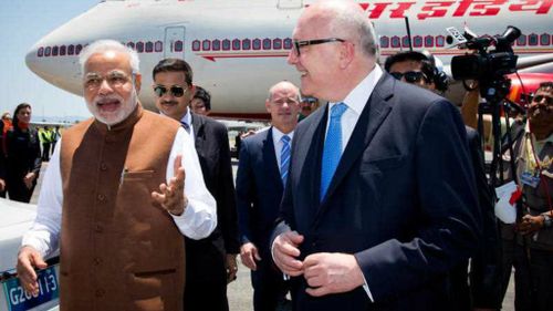 Indian Prime Minister Narendra Modi is greeted by Attorney-General George Brandis on the tarmac in Brisbane. (AAP)