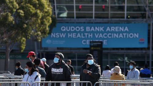 People queue to be vaccinated at the Qudos Bank Arena NSW Health Vaccination Centre in Sydney.