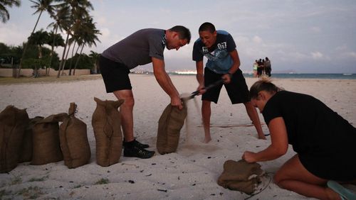 Residents prepare sandbags for the approaching storm