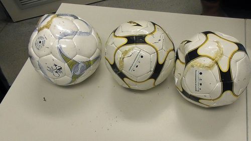 A photo of the three soccer balls seized at a NSW prison. 