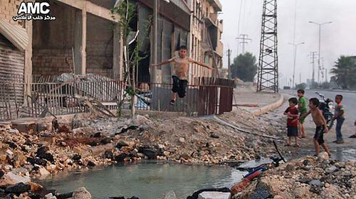 Syrian boys swim in Aleppo crater as war rages around them