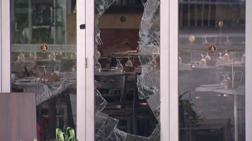 Le cicatrici dell'attacco sono ancora visibili nel ristorante, con le porte di vetro sfondate.