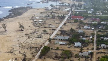 In this photo supplied by the Royal Australian Navy, an Australian Defence Force MRH-90 Taipan helicopter provides aerial reconnaissance of Eua Island in Tonga  on Feb. 21, 2022. Three months on from a devastating volcano and tsunami in Tonga, the AP checks in on how the island nation is recovering. The bill from the tsunami is estimated at some $90 million and GDP is expected to fall by more than 7% this year. The cleanup has been hindered by an internet outage caused by the tsunami and the nat