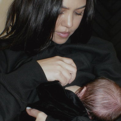 Kourney Kardashian breastfeeds her baby.